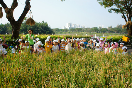 HO CHI MINH CITY, VIET NAM- FEB12: Group of unidentified Asian kid with outdoor activity of preschool, little boy, girl in uniform, Vietnamese children visit park in springtime, Vietnam, Feb 12, 2015のeditorial素材