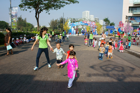 HO CHI MINH CITY, VIET NAM- FEB12: Group of unidentified Asian kid with outdoor activity of preschool, little boy, girl in uniform, Vietnamese children visit park in springtime, Vietnam, Feb 12, 2015のeditorial素材
