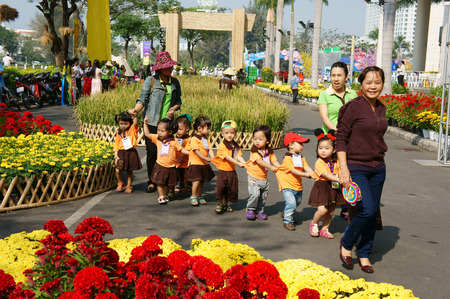 HO CHI MINH CITY, VIET NAM- FEB12: Group of unidentified Asian kid with outdoor activity of preschool, little boy, girl in uniform, Vietnamese children visit park in springtime, Vietnam, Feb 12, 2015のeditorial素材