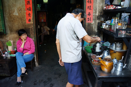 HO CHI MINH CITY, VIET NAM- FEB 7: Asian man with private business at home by cafe store, Vietnamese male earning money when elderly, ancient coffee shop with tradition make, Vietnam, Feb 7, 2015のeditorial素材