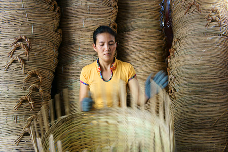 VINH LONG, VIET NAM- MAR 24: Asia trade village at Mekong Delta, Vietnamese people work inside to make basket from bamboo material, clever hand and hard working to make product, Vietnam, Mar 24, 2015のeditorial素材