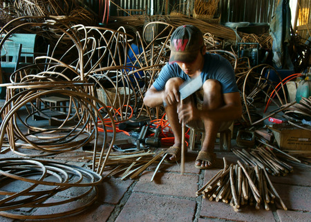 LAM DONG VIET NAM MAY 1: Vietnamese worker working inside of home at trade village  to make traditional product rattan basket from nature material clever hand Vietnam May1 2015のeditorial素材