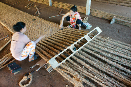 BEN TRE, VIET NAM- JUNE 1: Asian worker work inside coir mat workshop, Vietnamese woman work traditional craft, coconut matting to export, coconut fiber material at Mekong Delta, Vietnam, June 1, 2015のeditorial素材