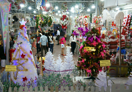 HO CHI MINH CITY, VIET NAM- DEC 17: Vietnamese people shopping at market place to buy ornament for Christmas holiday, colorful decoration for winter season show at store, Saigon, Vietnam, Dec 17, 2014のeditorial素材