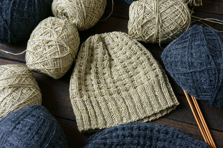 Handmade gift for couple on wintertime, woollen hat in black and beige color, woman hand knitting...