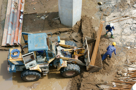 LONG AN, VIET NAM- OCT 14: Asian worker working at construction site, a dredge the river bed...