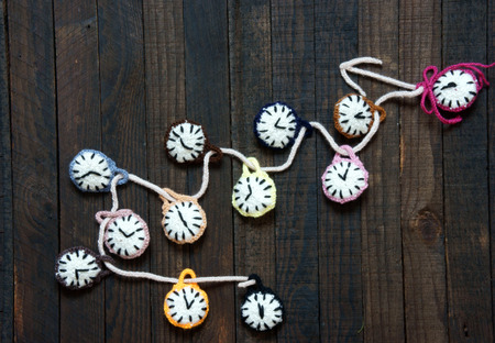Handmade design from yarn, group of colorful clock with many time zone to happy new year 2016, eve moment, amazing with knitted product on wooden backgroundの写真素材