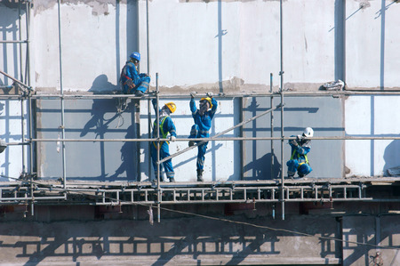 HO CHI MINH CITY, VIET NAM- NOV17: Group of Asian construction worker working on scraffold at...