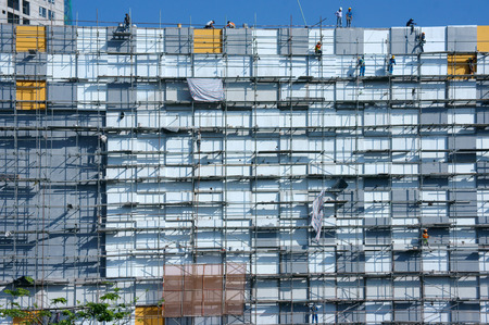 HO CHI MINH CITY, VIET NAM- NOV17: Group of Asian construction worker working on scraffold at...