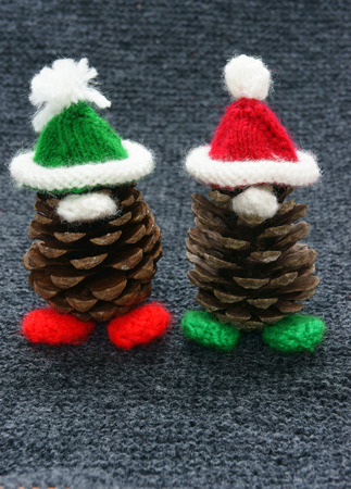 Christmas pine gnome, pinecone wear Xmas hat for decoration on winter holiday, with red, green yarn, homemade product by knitted hat, food, nose make amazing and pretty giftの写真素材