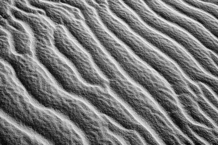 Black and white background of nature on sand hill, amazing wavy pattern with abstract shape and shadow, amzing art from sand in monotoneの写真素材