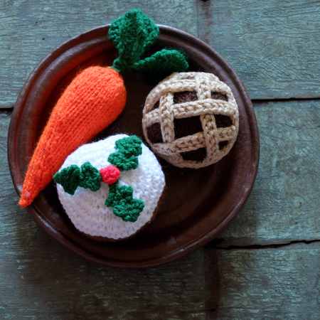 Group of food as carrot, mince pie, cupcake, meal to treat for santa claus and rudolph on christmas night, amazing xmas ornament handmade by knit from colorful yarnの写真素材
