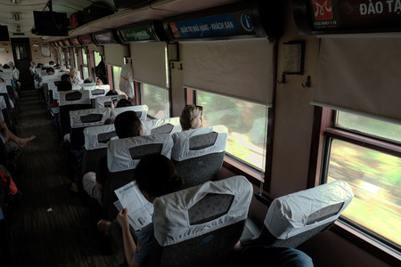 HO CHI MINH CITY, VIET NAM- AUG 7, 2016: Group of Vietnamese passenger sit in wagon train, people with public transport service for long journey by, train moving on rail, Vietnamのeditorial素材