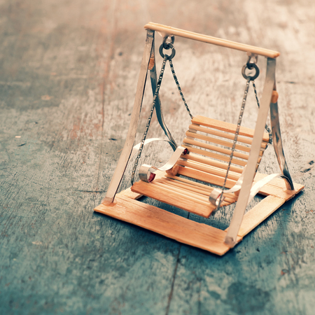 Amazing miniature handmade product for interior design, mini furniture make from wood stick on wooden background, small swing so cute, a hobby leisureの写真素材