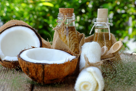 Nature cosmetic products, coconut oil from copra in glass jar on green background, essential oil for skin care, rich vitamin, organic cosmetic also massage oil at spaの写真素材