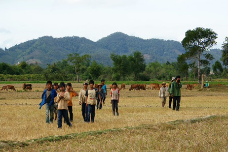 DAK LAK, VIET NAM- DEC 31, 2012: Group of dirty Asian children play on meadow at Vietnam countryside, group of ethnic minority boy at poor villageのeditorial素材