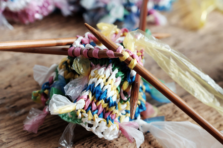 Cut nylon bag into yarn and knit to basket, good idea to recycle nylon bag to reduce environmental pollutionの写真素材