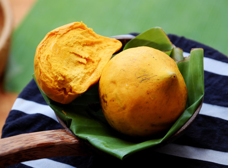 Close up of yellow canistel fruit on green background, also name egg fruit, a sweet and delicious...