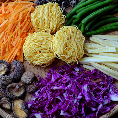 Raw materials for fry noodles mixed vegetables from top view, a Vietnamese vegetarian dish for vegans, with colorful greens, vermicelli and mushrooms, quick to  make for breakfast at homeの写真素材