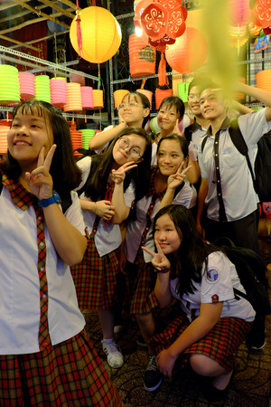 HO CHI MINH CITY, VIETNAM- SEPT 24, 2018: Group of Vietnamese pupils enjoy with friend and selfie by smartphone at outdoor lantern street , Vietnamのeditorial素材