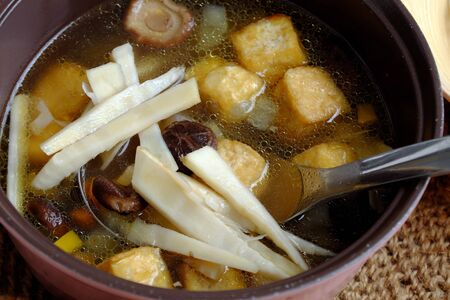 Soup pot for vegan bun mang or bamboo shoot noodles with tofu, mushroom, laksa leaves, herbs, an simple dish from vegetables but delicious for vegetarianの写真素材