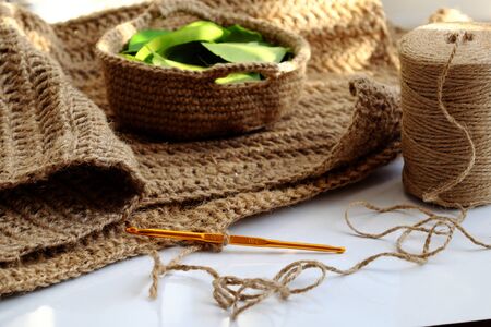 Close up crochet hook with ball of jute rope to make decor handmade product, table dishcloth or mat...