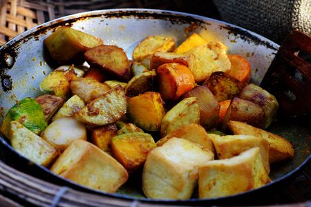 High view raw material of vegan curry dish with bread for breakfast, vegetarian meal cook from taro, sweet potato, carrot, coconut milk and curry powder, homemade Vietnamese foodの写真素材