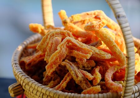 Vietnamese traditional food for tet holiday, close up carrot jam in basket on bamboo background, sweet snack food from vegetable for tea time in spring seasonalの写真素材