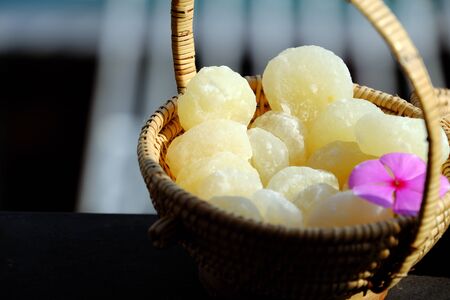 Vietnamese traditional food for tet from vegetables, close up homemade sweet water chestnut jam in white in basket on bamboo background for tea time at spring seasonalの写真素材
