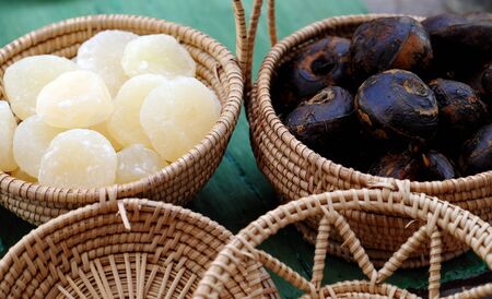 Vietnamese traditional food for tet from vegetables, close up homemade sweet water chestnut jam in white in basket on bamboo background for tea time at spring seasonalの写真素材