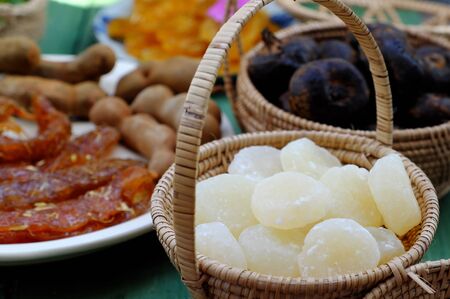 Vietnamese traditional food for tet from vegetables, close up homemade sweet water chestnut jam in white in basket on bamboo background for tea time at spring seasonalの写真素材