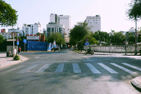 HO CHI MINH CITY, VIET NAM- APRIL 4, 2020: Deserted street, silent scene at central area of big city by request limit move around in pandemic, only few vehicle moving on dayのeditorial素材