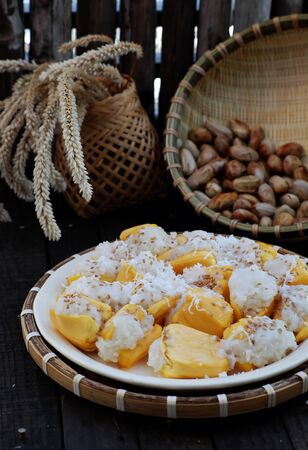 Close up plate of sticky jackfruit for breakfast from high view, delicious Vietnamese eating from jack fruit, sticky rice and chopped coconutの写真素材