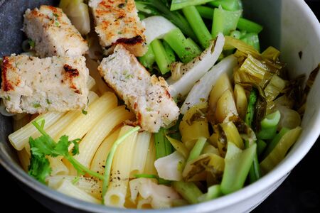 Close up vegetarian penne pasta soup bowl with vegetables for breakfast, vegan food from macaroni with kale, tofu pie for non meat diet but nutrition, healthy eating and deliciousの写真素材