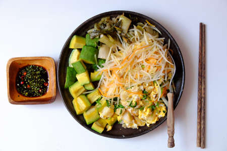Top view plate of fried dough with egg, simple and delicious dish for vegan meal on white background, eat with avocadoの写真素材