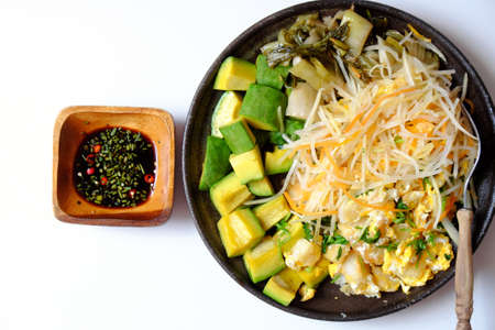Top view plate of fried dough with egg, simple and delicious dish for vegan meal on white background, eat with avocadoの写真素材