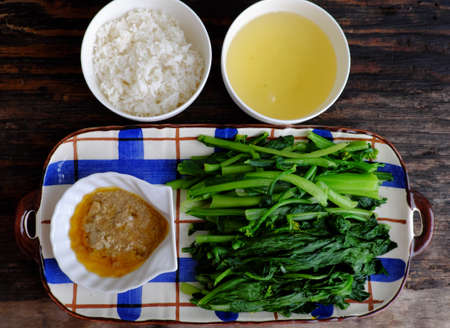Vietnamese healthy food with vegan ingredient, boiled choy sum with rice and tofu cheese, cheap and simple meal for lunch timeの写真素材