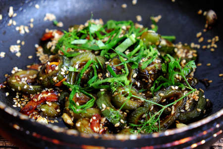 Close up from top view vegan dish for family daily meal, bitter melon cut in slice, then fry and cook with soy sauce and sesame, delicious vegetarian homemade Vietnamese foodの写真素材