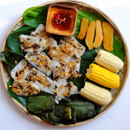 Top view simple tray of vegan food, rice flour leaf cake, boiled corn, sweet potato, nutrition eating, healthy menu for dietの写真素材