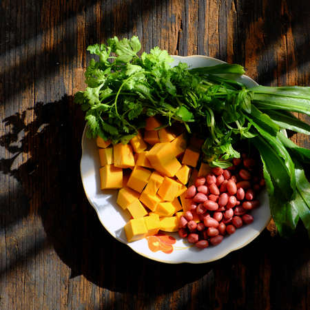 Top view raw material to cook pumpkin soup with peanut and coriander spice, simple dish for...
