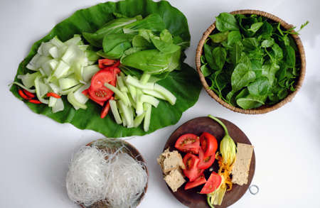 Vietnamese green vegetables hot pot for dinner weekend, tomato, bok choy, tofu skin, colocasia gigantea with noodles, delicious and healthy eating that rich fiber, vitamin for vegetarianの写真素材