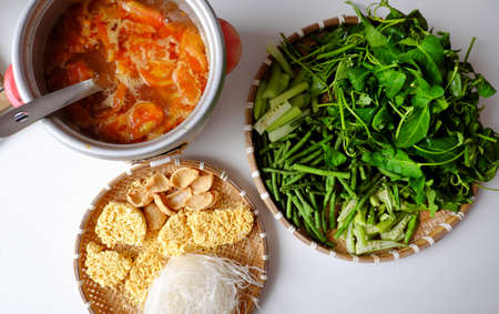 Top view Vietnamese vegan food, green vegetables hot pot homemade from tomato, soy protein, chili sate, amaranth, pepper elder, bun, spinach, healthy eating that rich fiber, vitamin for vegetarianの写真素材