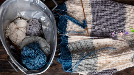 Top view, Vietnamese woman hands with ball of yarn to make winter present, female knitting woollen sweater, leisure activity, knit at home to make handicraft clothingの写真素材