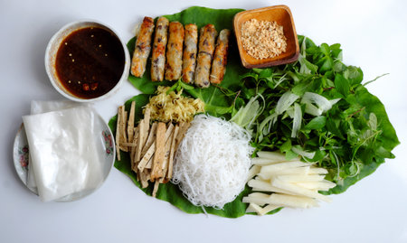 Top view Vietnamese homemade vegan food, fried spring rolls with bun herbal leaf and rice paper, healthy dish for lunch with non meat eatingの写真素材