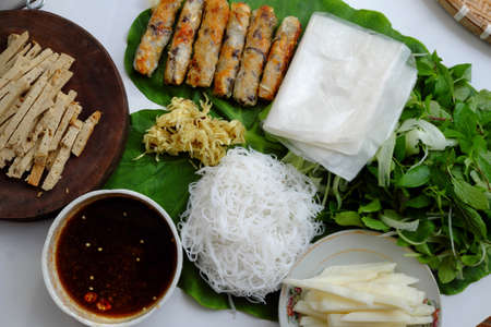 Top view Vietnamese homemade vegan food, fried spring rolls with bun herbal leaf and rice paper, healthy dish for lunch with non meat eatingの写真素材