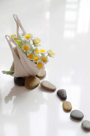 Amazing handmade product for home decor, diy flower pot recycle from face mask, tiny daisy crochet from yarn and pebble stone make art workの写真素材