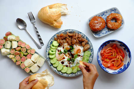 Top view woman hand prepare food for homemade breakfast, plate of omelet, sliced cucumber, jackfruit cook with sauce, non meat diet for healthy eating but nutrition and delicious on white backgroundの写真素材