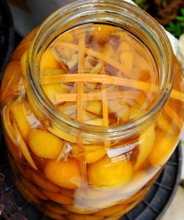 Big jar yellow salted kumquat and bask outdoor to make delicious beverage for hot summer dayの写真素材