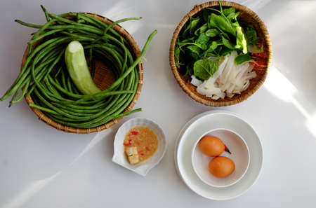 Top view vegan rice dishes for daily meal with non meat raw material, boiled vegetables as dragon bean, cowpea with tofu cheese, vegetable soup and desserts foodの写真素材