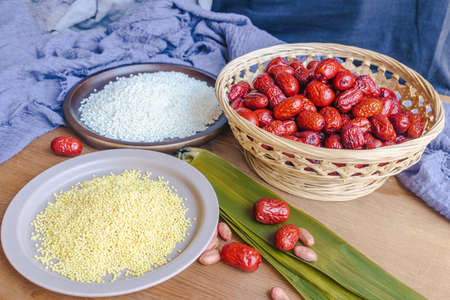 Chinese traditional festival Dragon Boat Festival, Zongzi and ingredients on the tableの写真素材